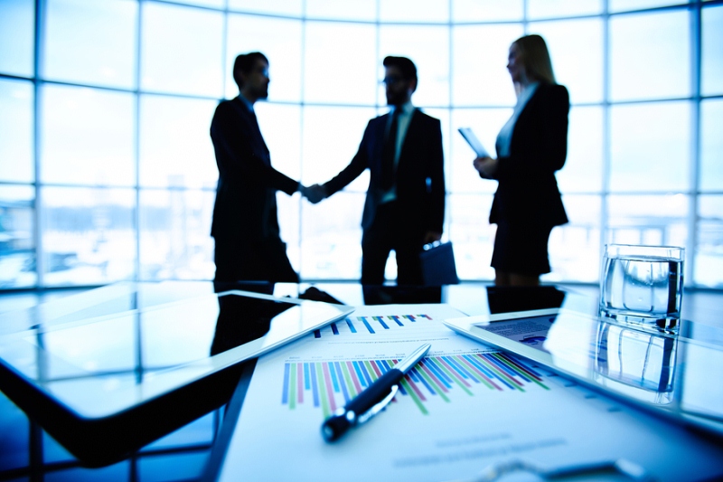 Business partners shake hands to the terms